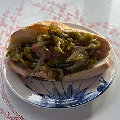 Juicy Italian Sausage layered with Sauteed Peppers and Onions, seved hot an an Italian Roll.