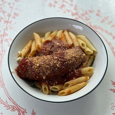 A creamy tomato-vodka sauce coats penne pasta, finished with fresh basil and Parmesan for a bold, flavorful Italian dish.